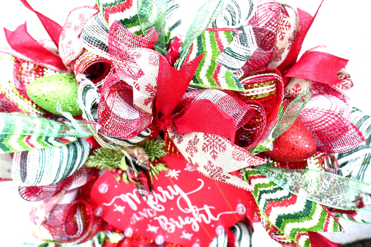 Close-up of glitter, snowflake and zigzag ribbons on the lighted Christmas wreath