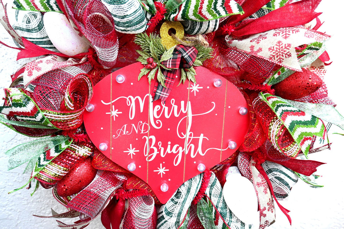 Close-up of the illuminated Merry and Bright sign on the Christmas wreath