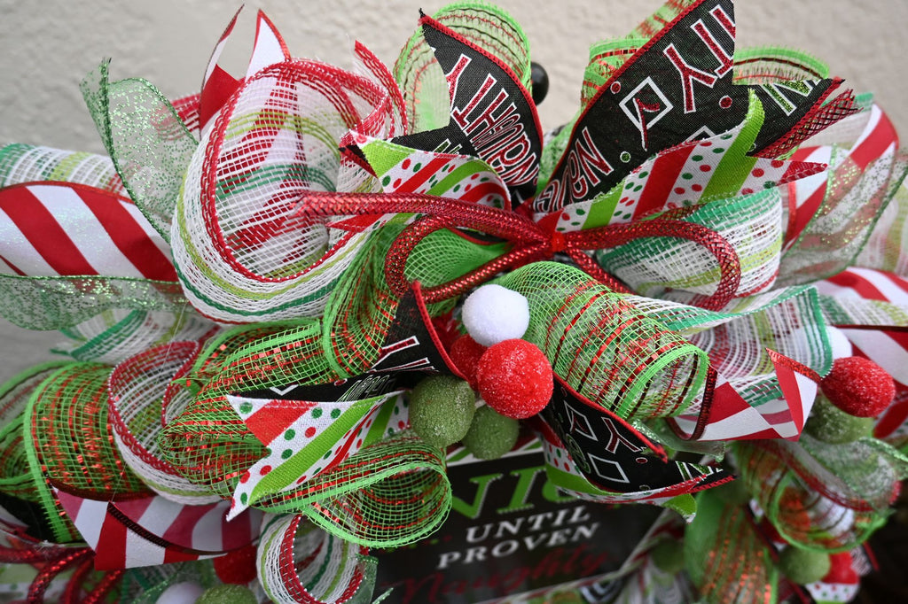 Close-up of checkbox, striped and lime glitter ribbons on the Naughty Nice wreath