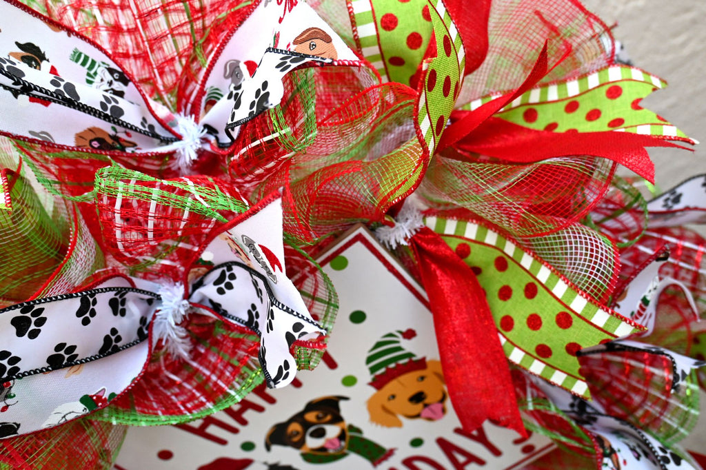 Close-up of dog, paw-print and glitter ribbons on the Happy Pawlidays Christmas wreath