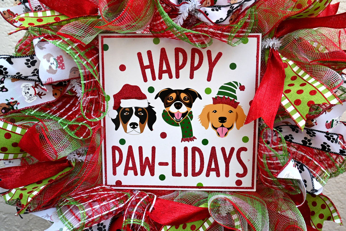 Happy Pawlidays wreath sign featuring three dogs in Christmas hats
