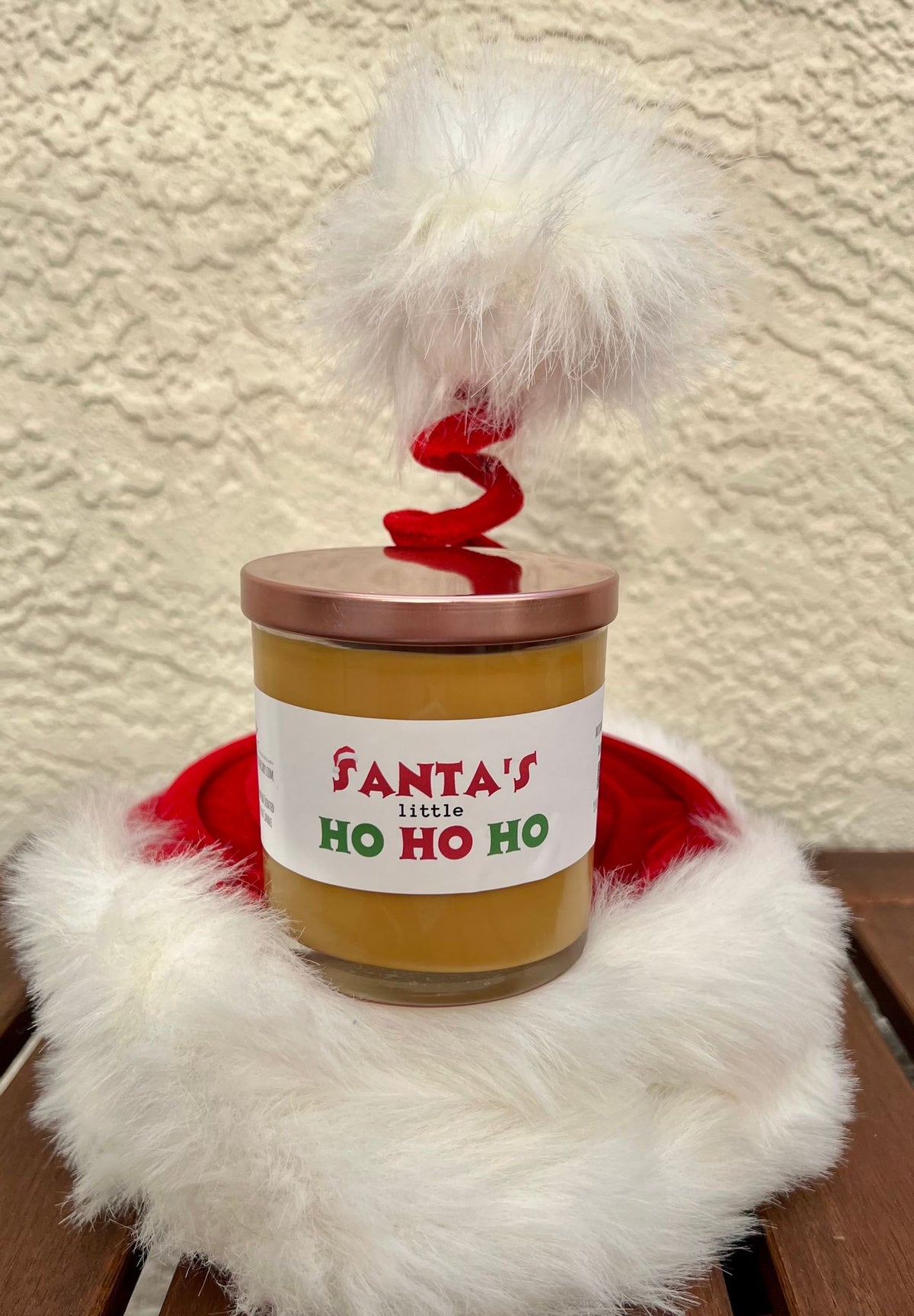 Closed Santa's Little Ho gingerbread Christmas candle with lid, a funny adult holiday gift and white elephant party candle.