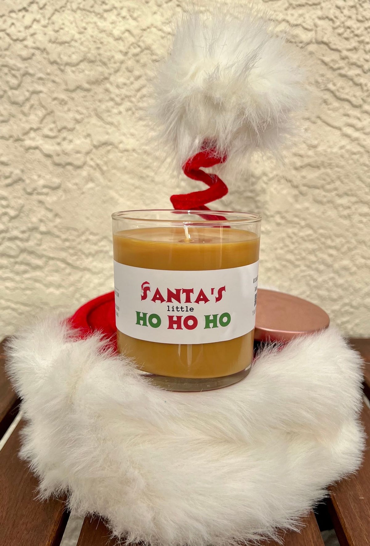 Open Santa's Little Ho gingerbread scented candle, a cheeky Christmas gag gift for grown-up holiday parties and Secret Santa.