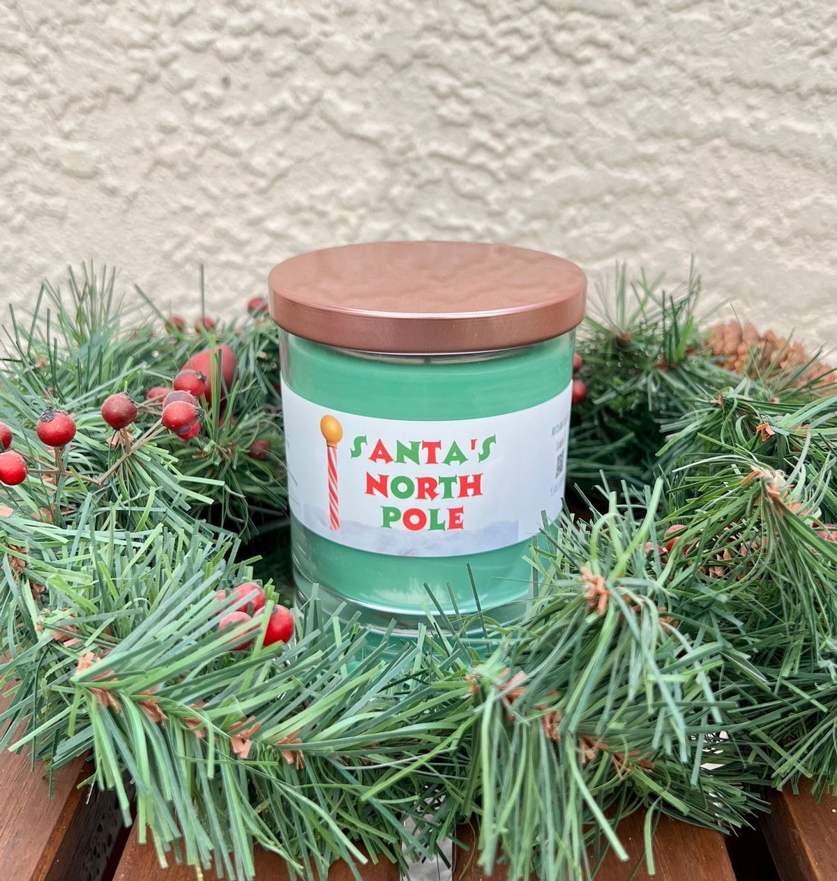 Santa North Pole evergreen spice candle styled for Christmas with festive holiday decor and warm seasonal fragrance.