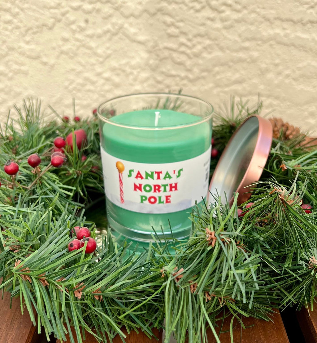 Open Santa North Pole candle showing evergreen spice scented wax in a festive Christmas candle jar.