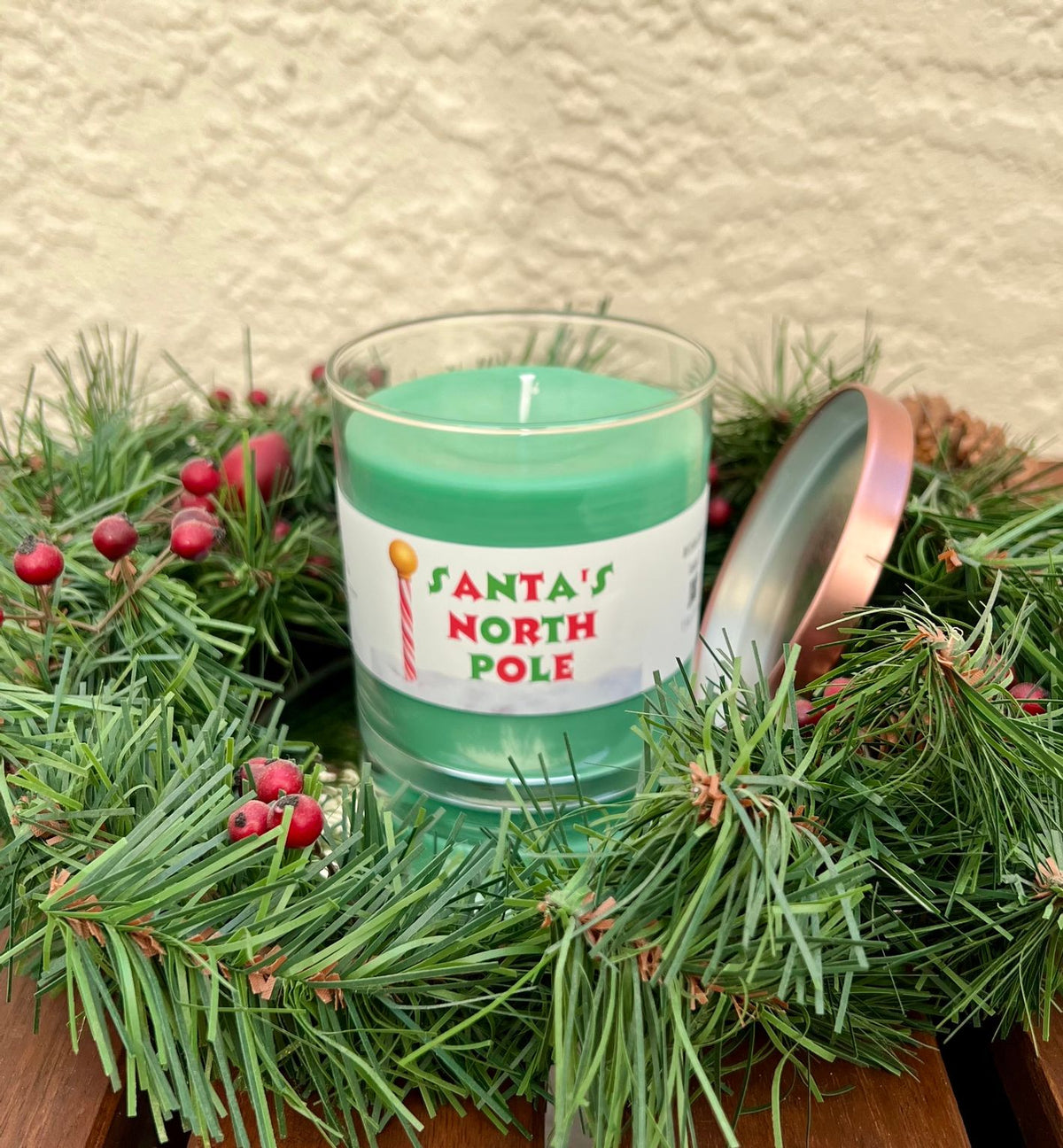 Open Santa North Pole candle showing evergreen spice scented wax in a festive Christmas candle jar.