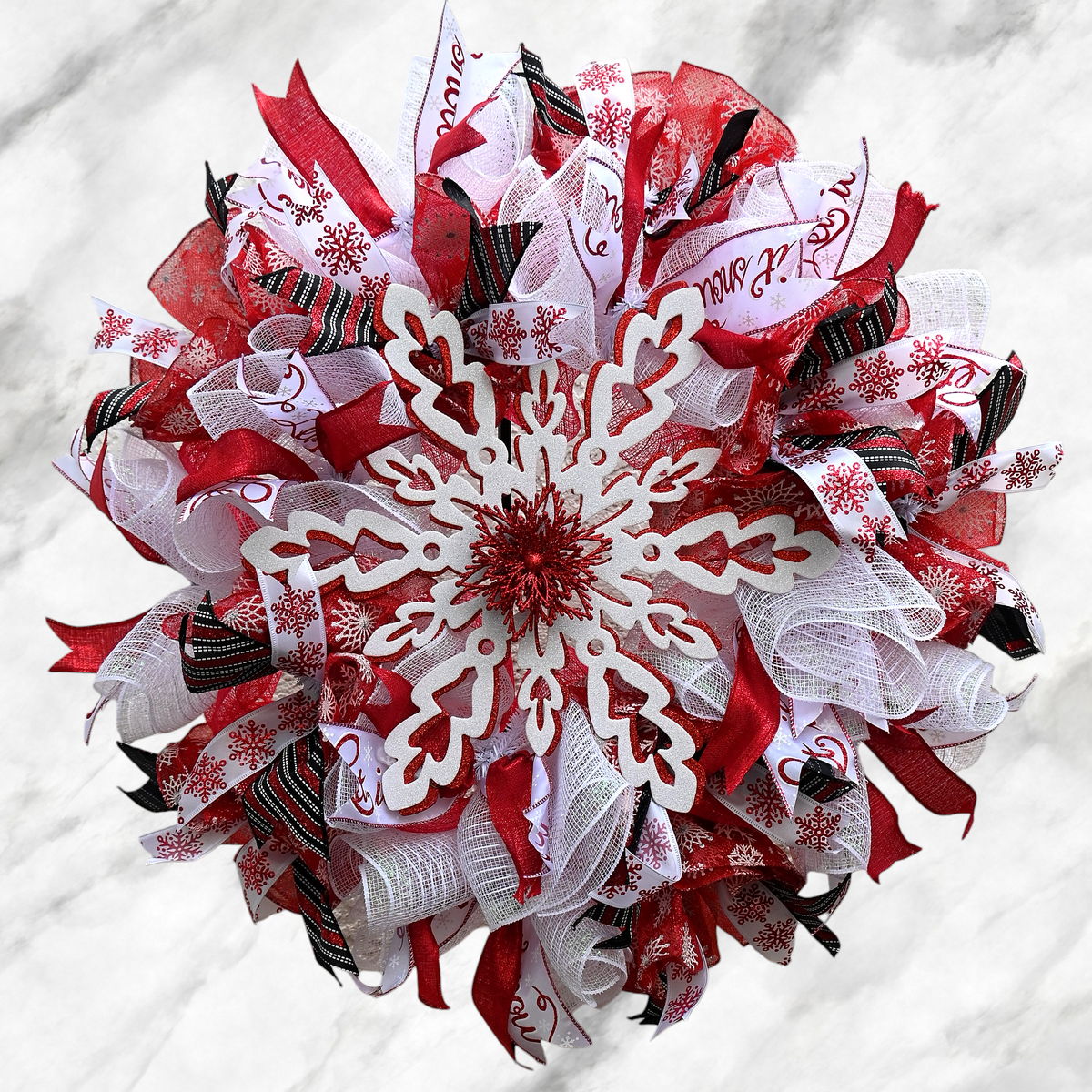 Winter Snowflake Wreath with red and white accents, glittery snowflakes, and layered ribbon for festive winter front door decor.