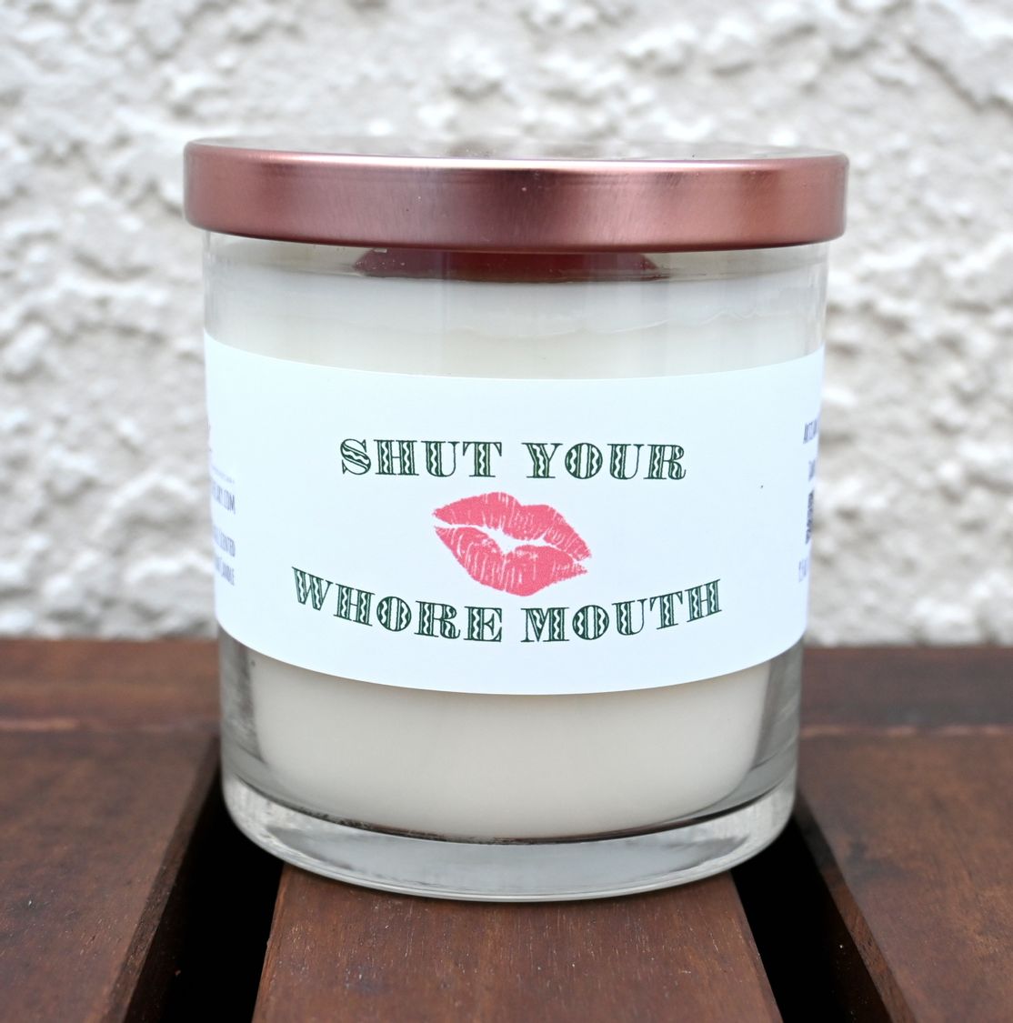 Closed Shut Your Whore Mouth mint and basil candle with rose-gold-tone lid and printed label