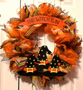 24-inch Halloween wreath with three witch hats and a "The Witch Is In" sign in orange, black, white and yellow