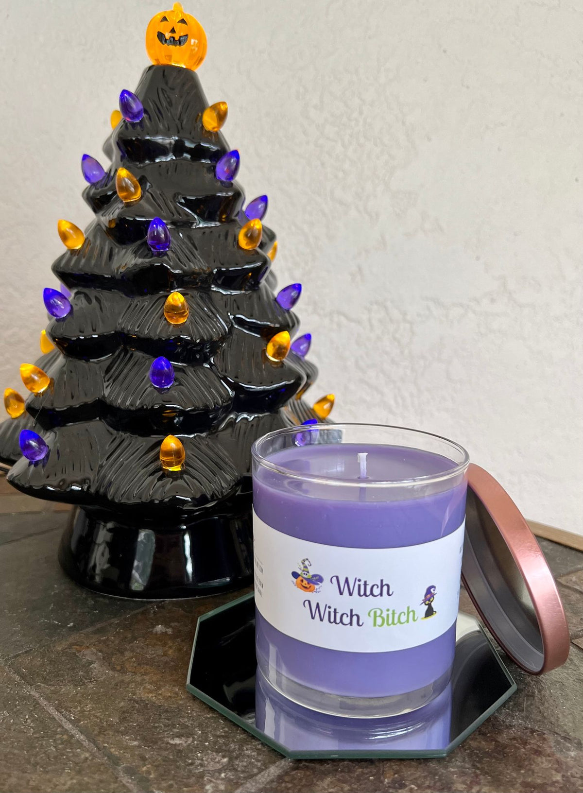 Open Witch Witch Bitch Halloween candle in a decorative jar with Berry Witch's Brew fragrance featuring peach, apricot, blackberry, spice, and musk.